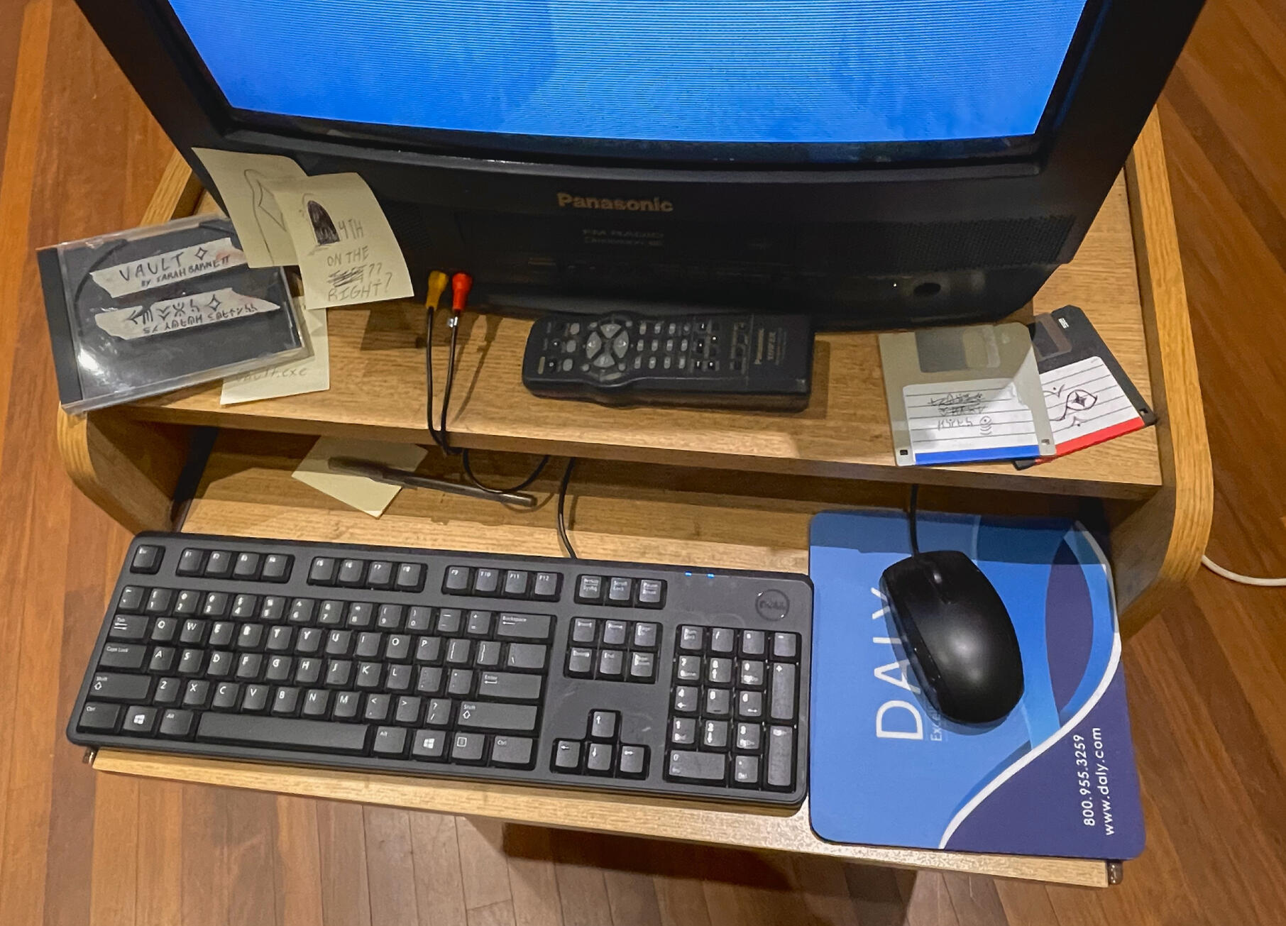 set dressing including floppy disks, a fake DVD case for the game, and sticky notes with messages some of which are hints for the game